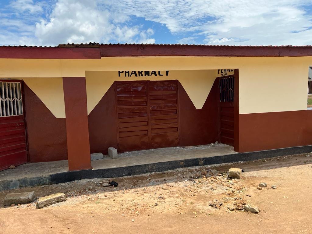 A single-storey building on the clinic site with PHARMACY painted across the front