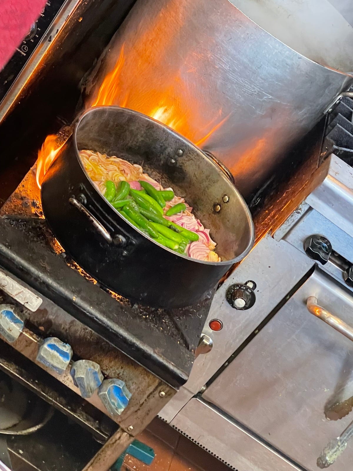A large cooking pot on a gas flame in the Hot Meals kitchen