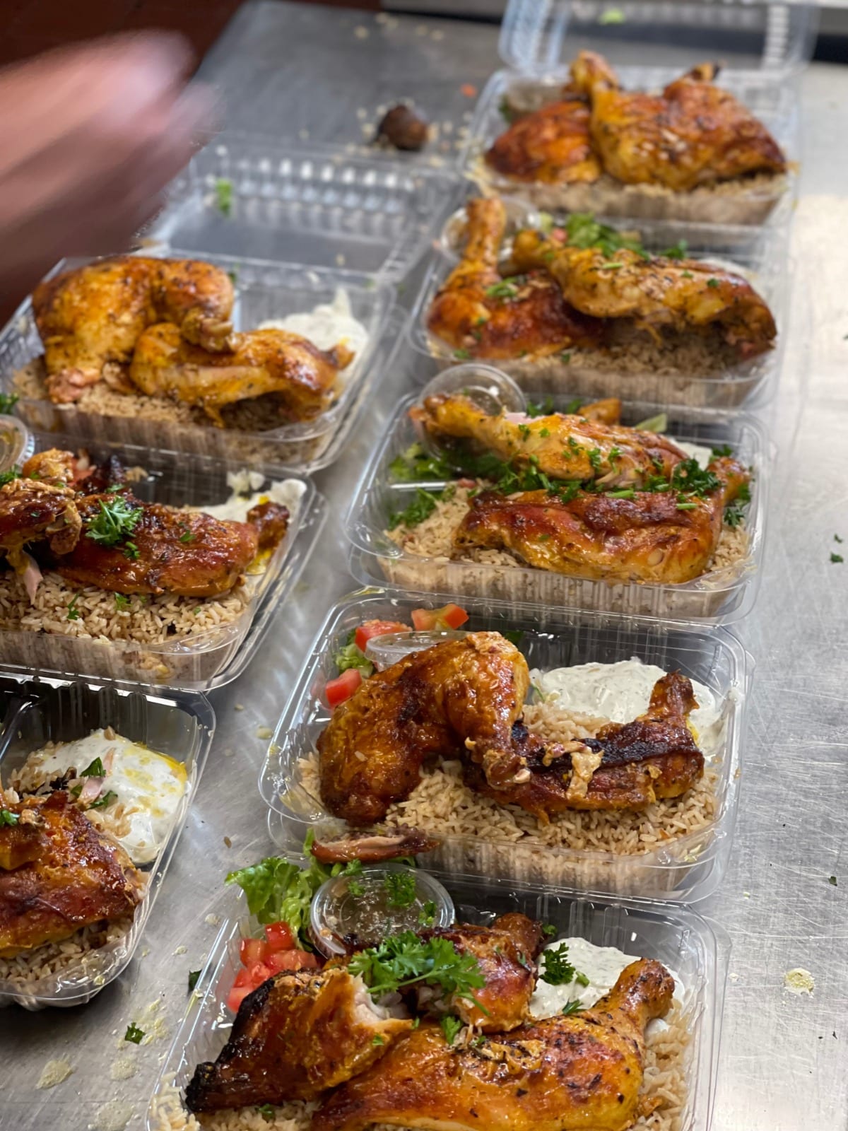 Foil trays of hot food packed in rows and ready to be taken out for delivery