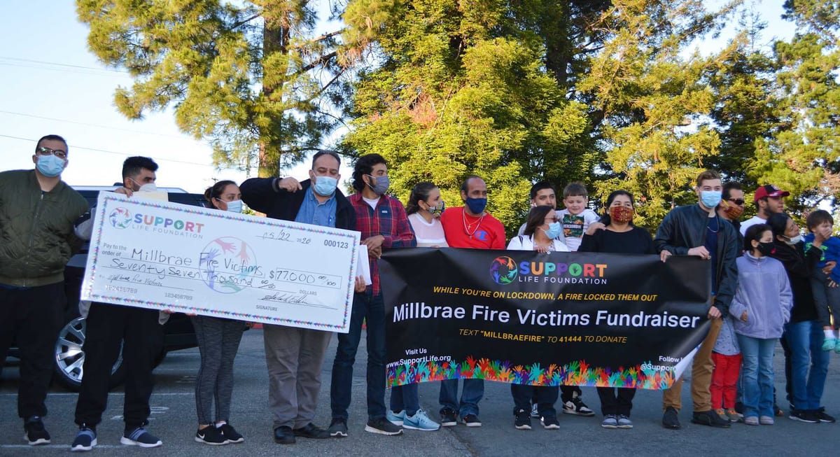 An oversized presentation cheque from the Millbrae Fire Victims Fundraiser, made out for around $77,000